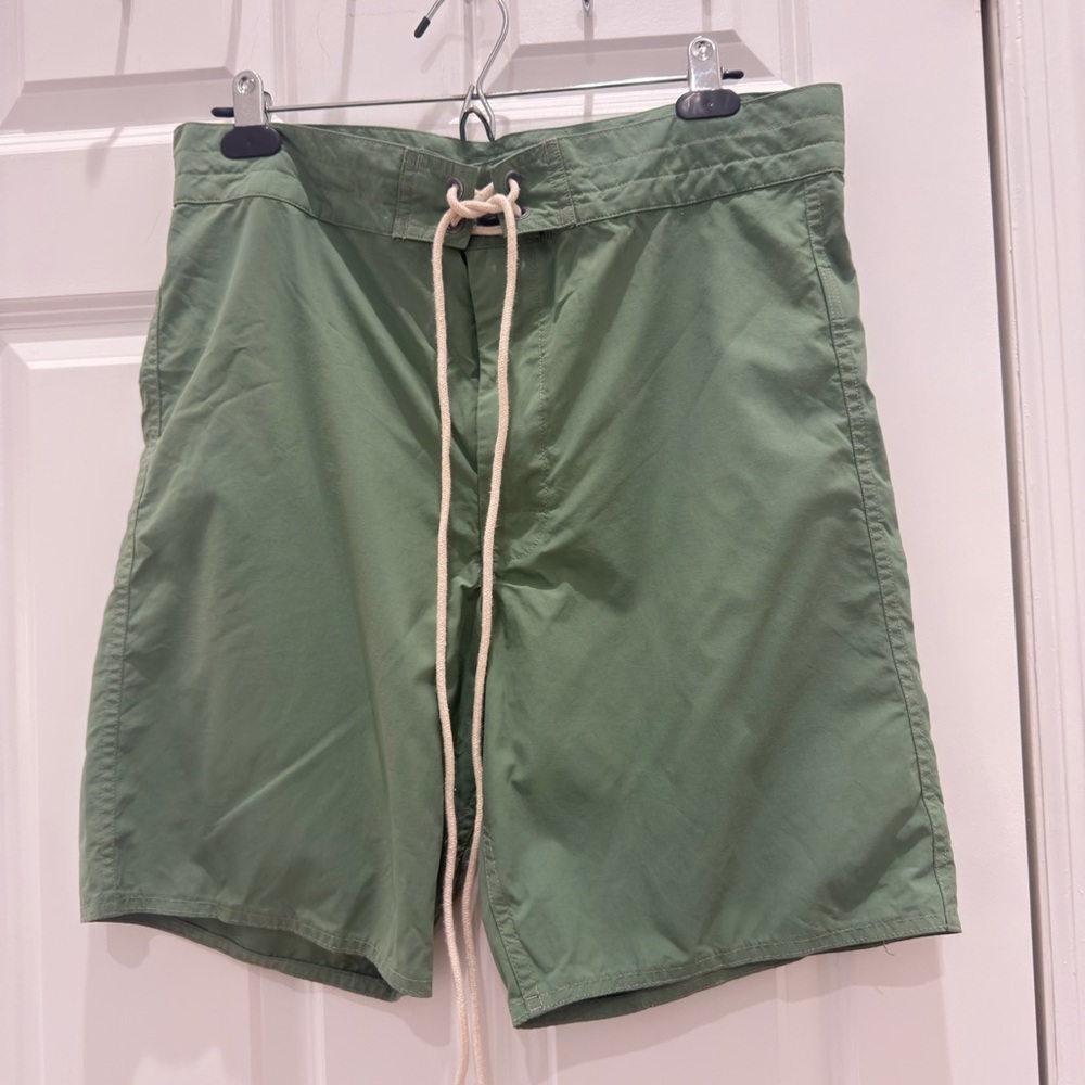 This is a pair of RRL green lace-up swim shorts made of 100% nylon. (